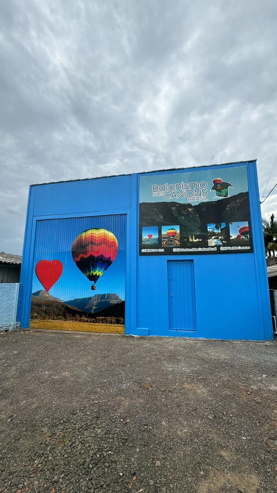Hot air balloons floating over the lush green canyons of Praia Grande in the early morning light