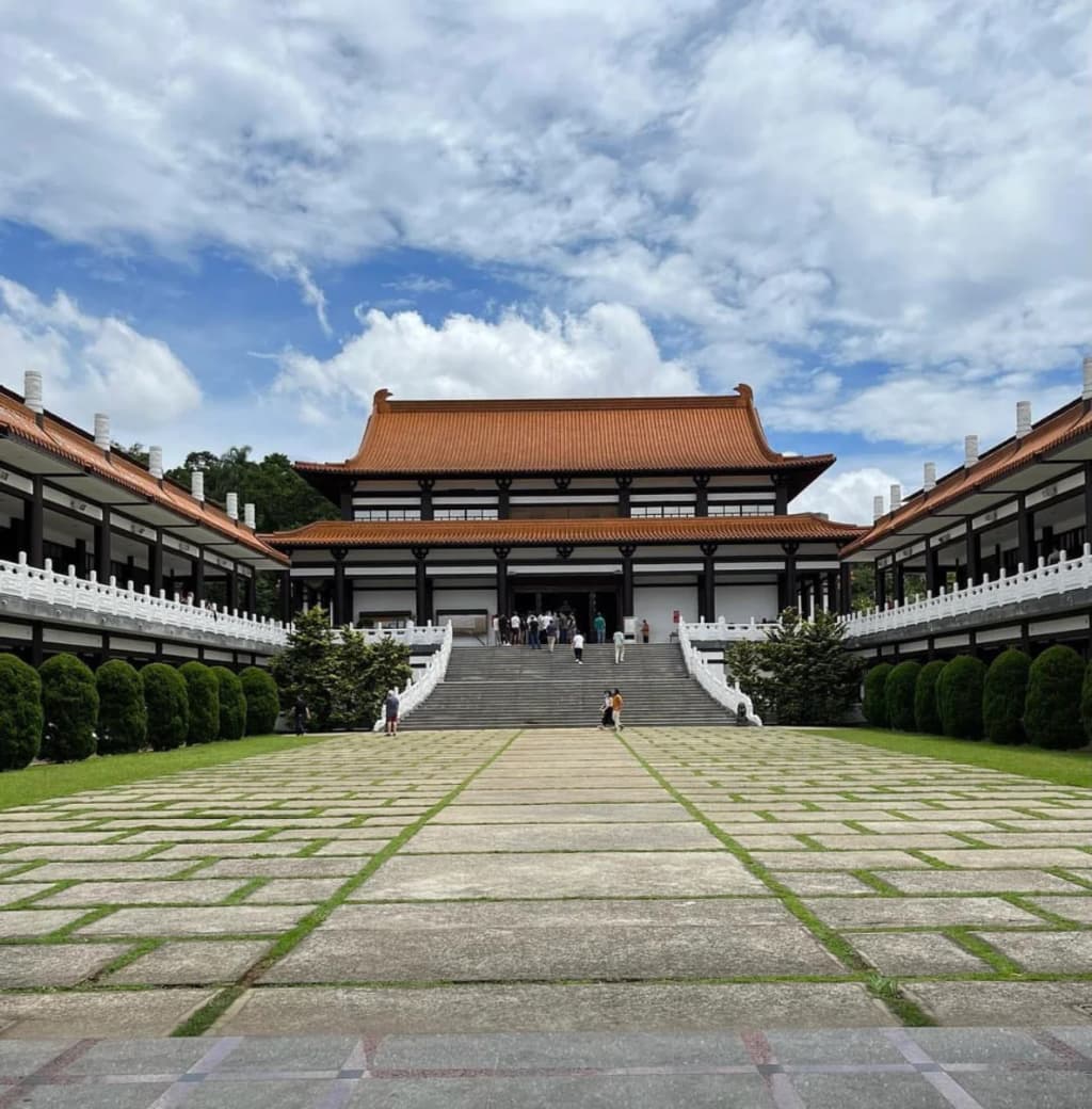 Zu Lai Temple Cotia entrance with statues and flowers