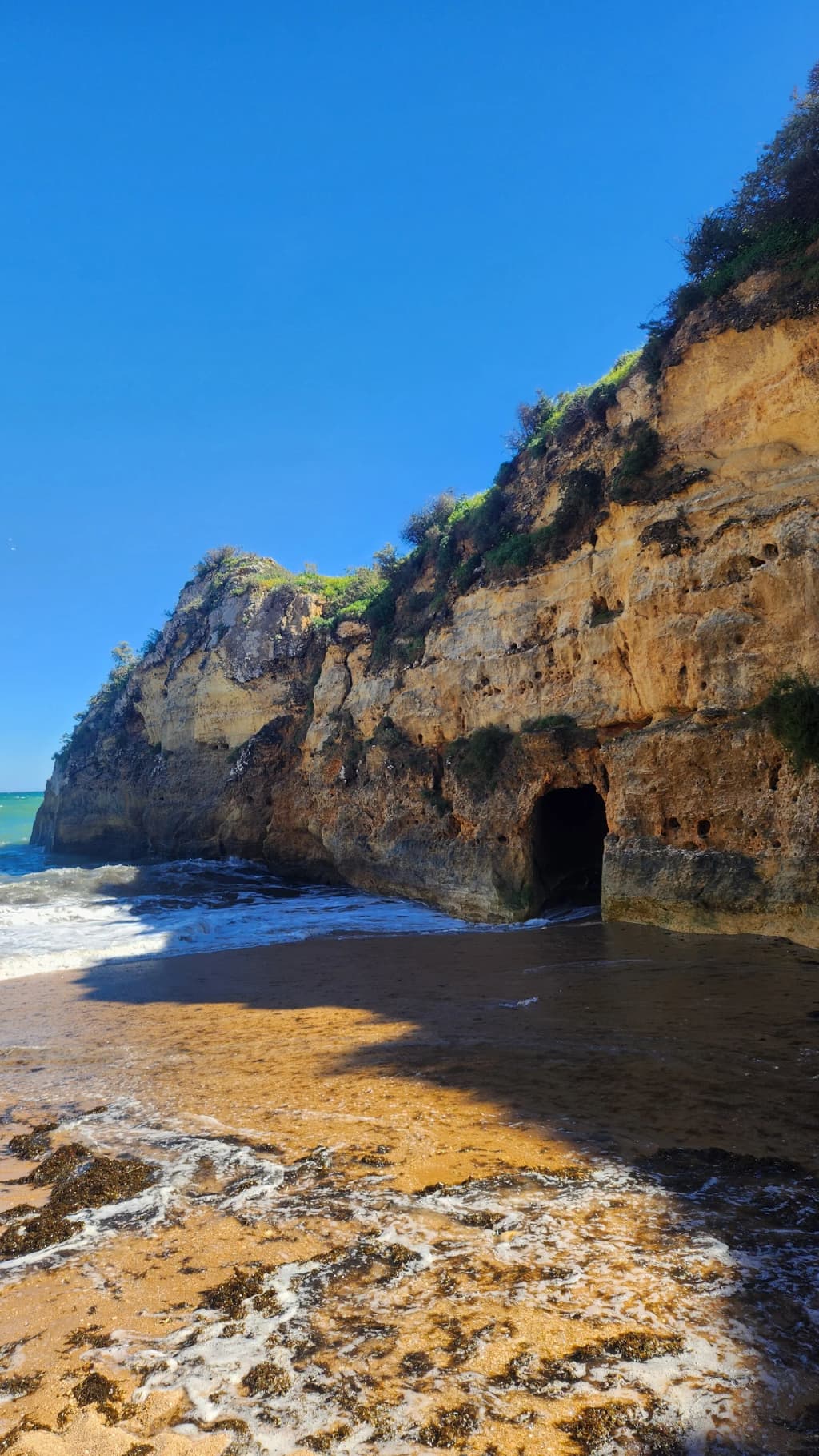 Cliffs and golden sands at Praia da Batata in Lagos