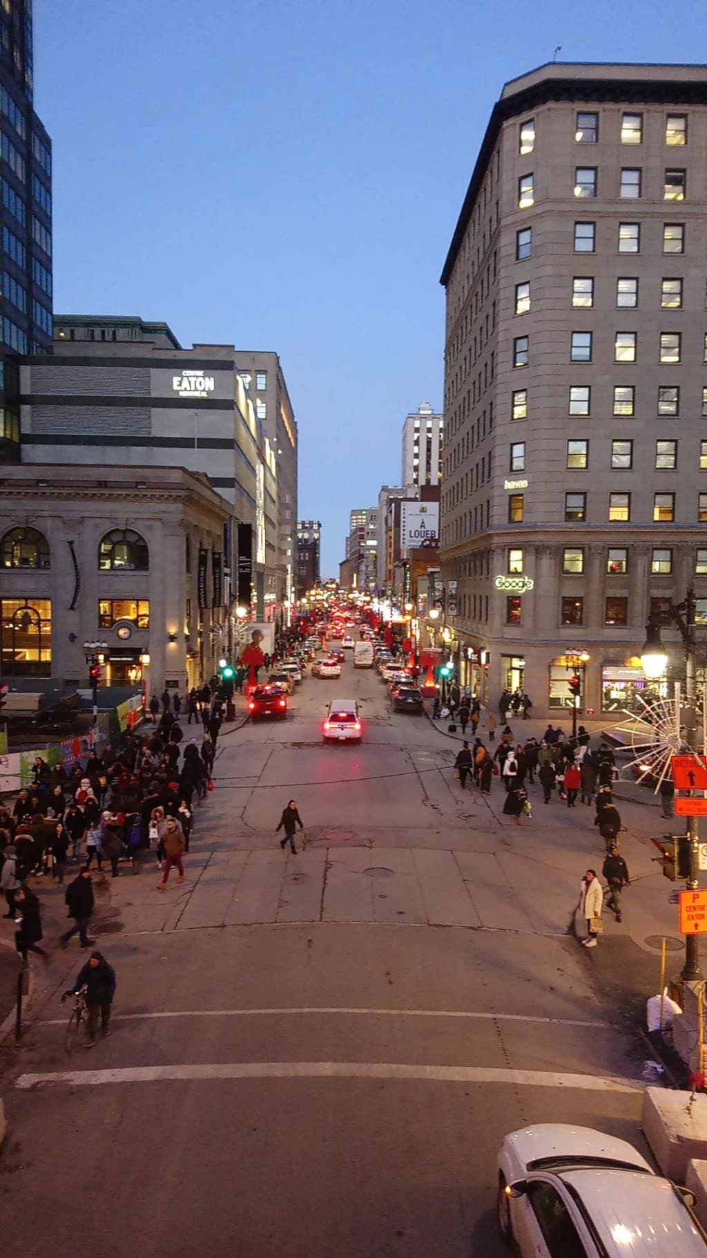 Pedestrians walking along Sainte-Catherine Street in Montreal