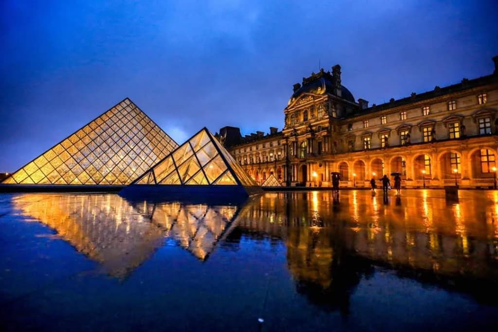 Visitors exploring the intricate architecture of the Louvre Museum