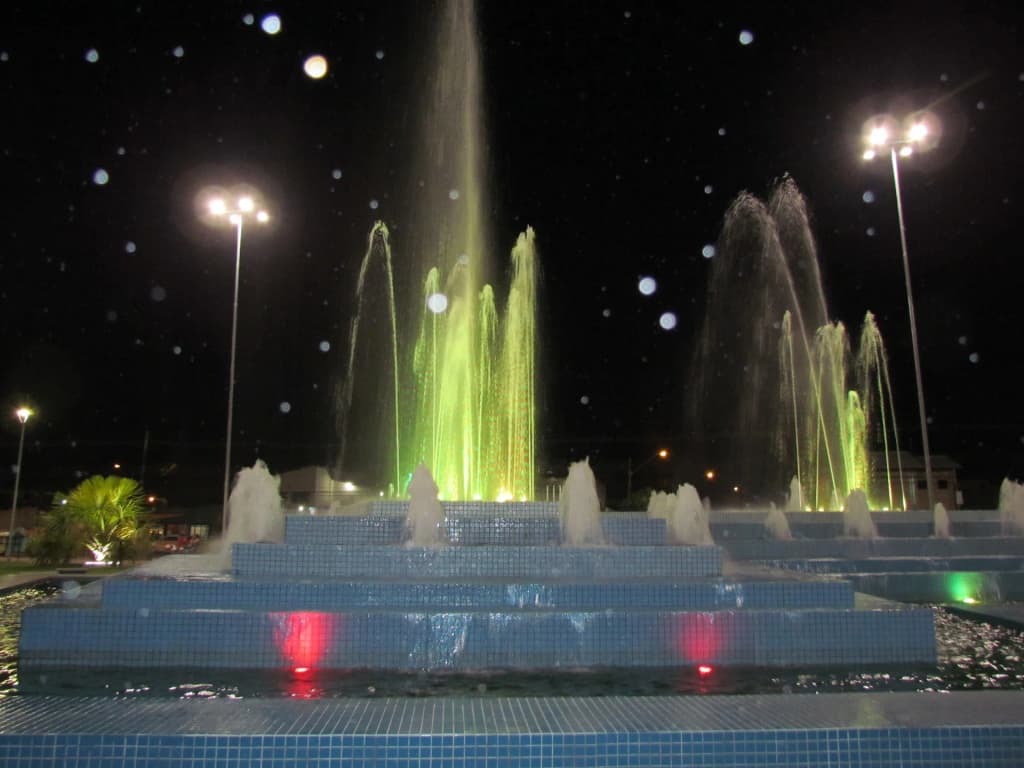 Illuminated water fountains dancing to music at Praça das Águas in the evening
