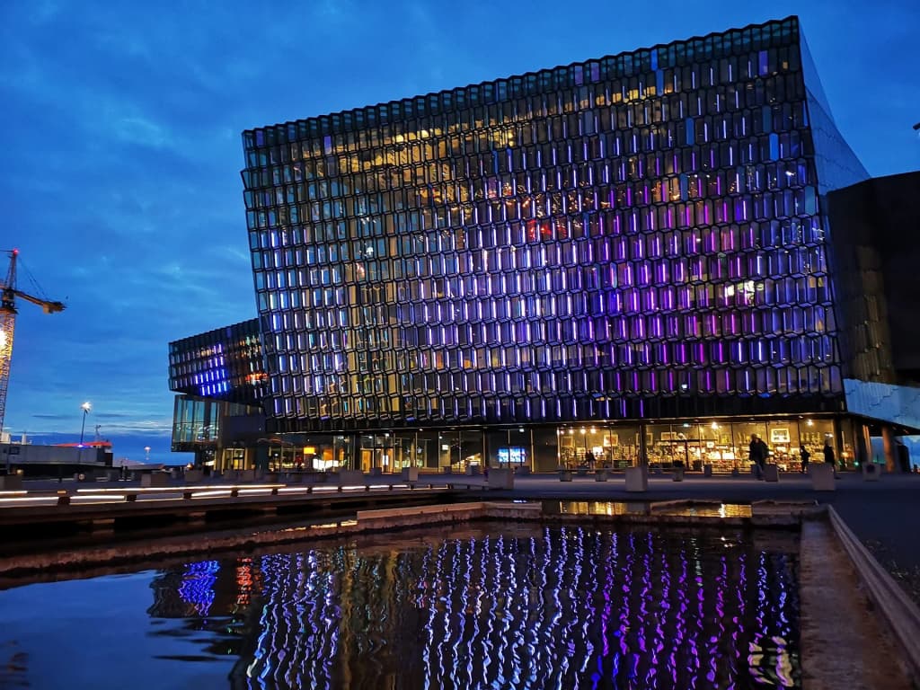 The glass honeycomb exterior of Harpa Concert Hall reflecting the pale northern light