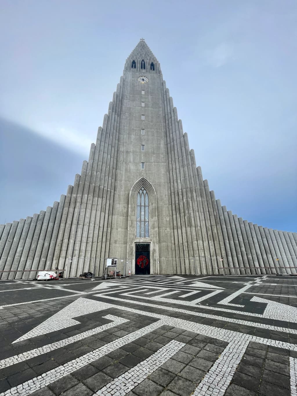 The towering concrete pillars of Hallgrimskirkja church reaching toward the clouds in central Reykjavik