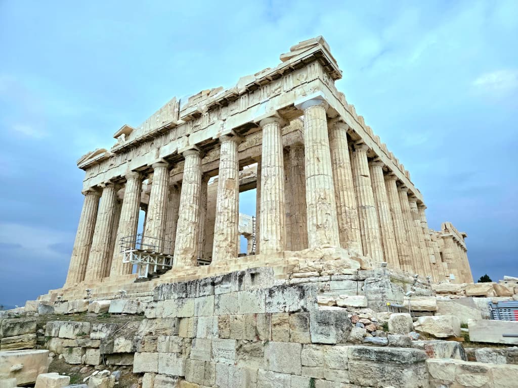 Ancient marble pillars of the Acropolis standing tall over the city of Athens