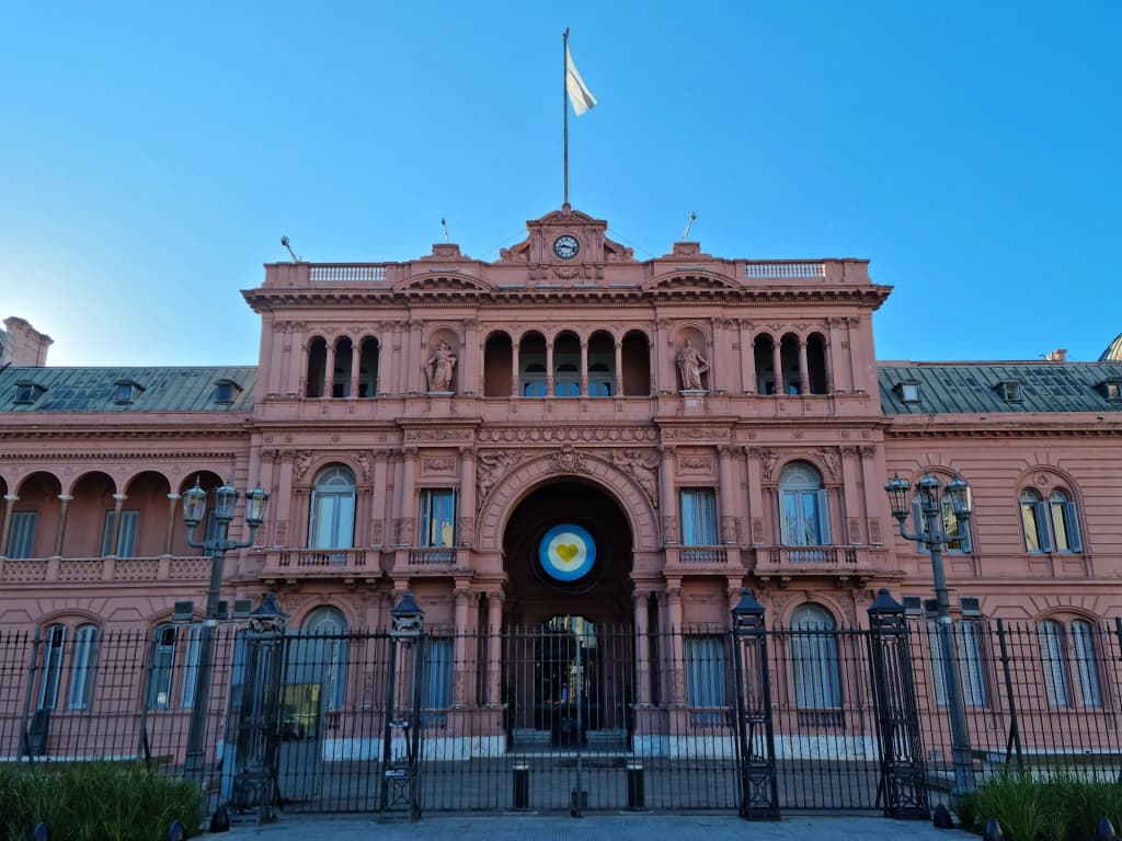 The iconic pink facade of Casa Rosada glowing in the Buenos Aires sunlight