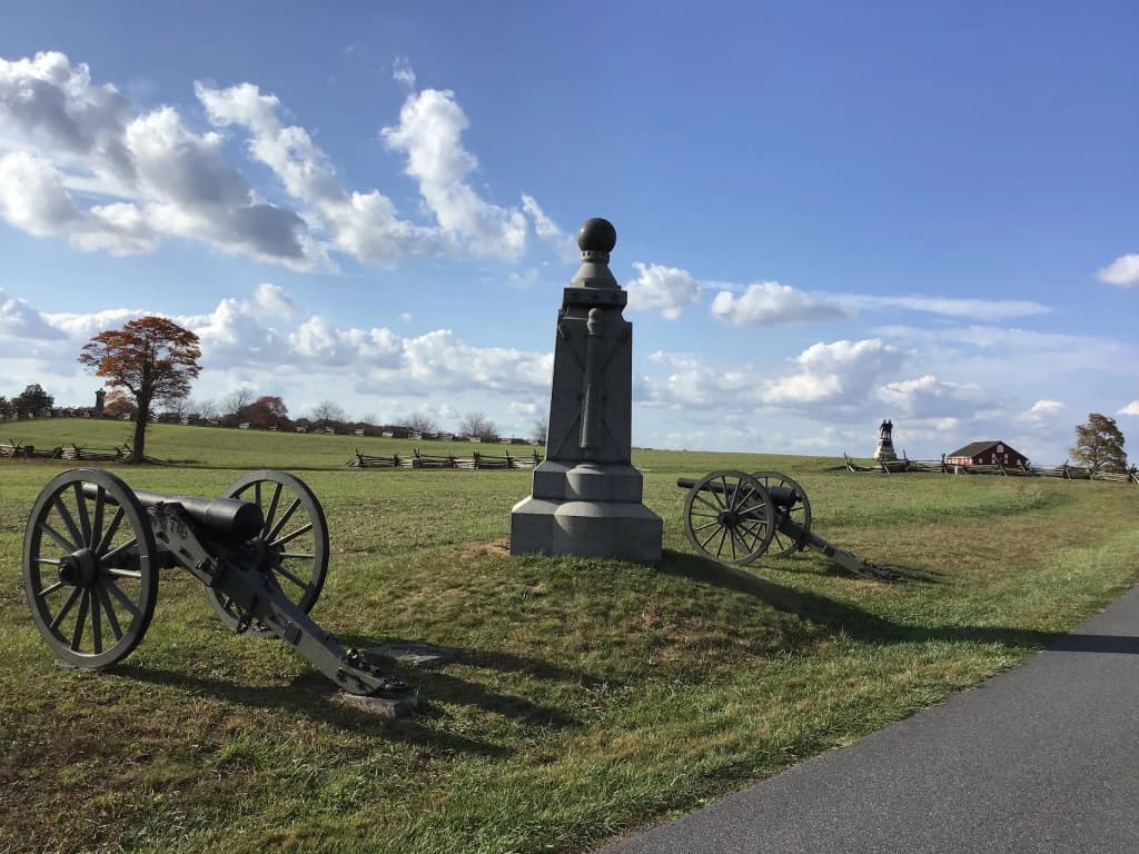 Rolling green fields and stone monuments stretching across Gettysburg National Military Park