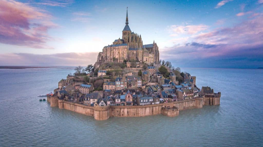 Mont Saint-Michel rising from the tidal flats at sunrise