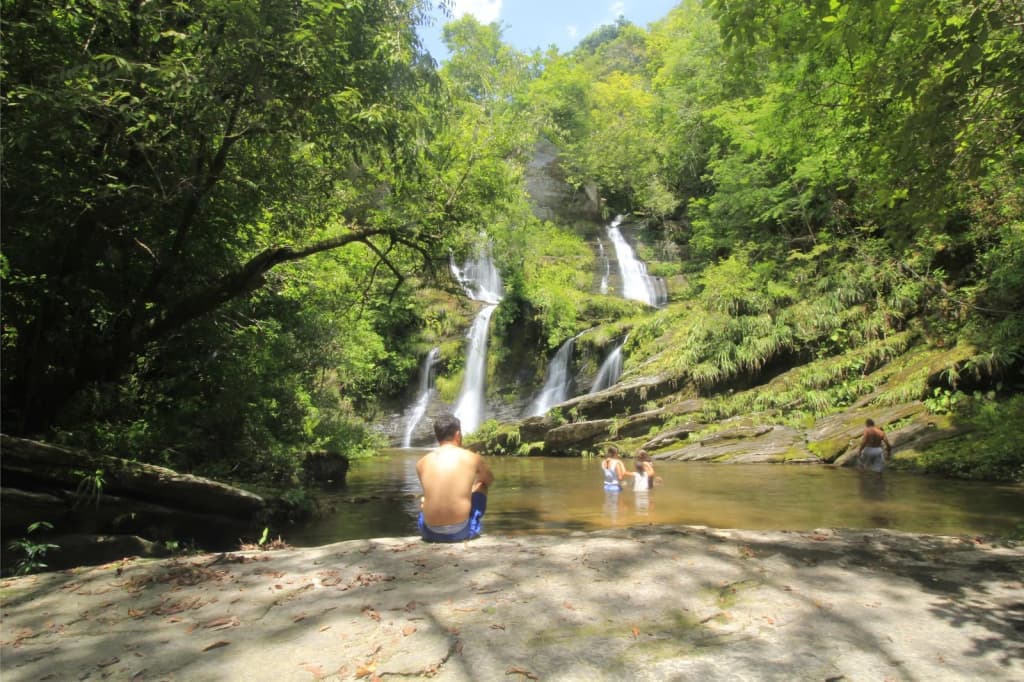 Inside Gruta dos Caldeirões, with limestone formations and a pool