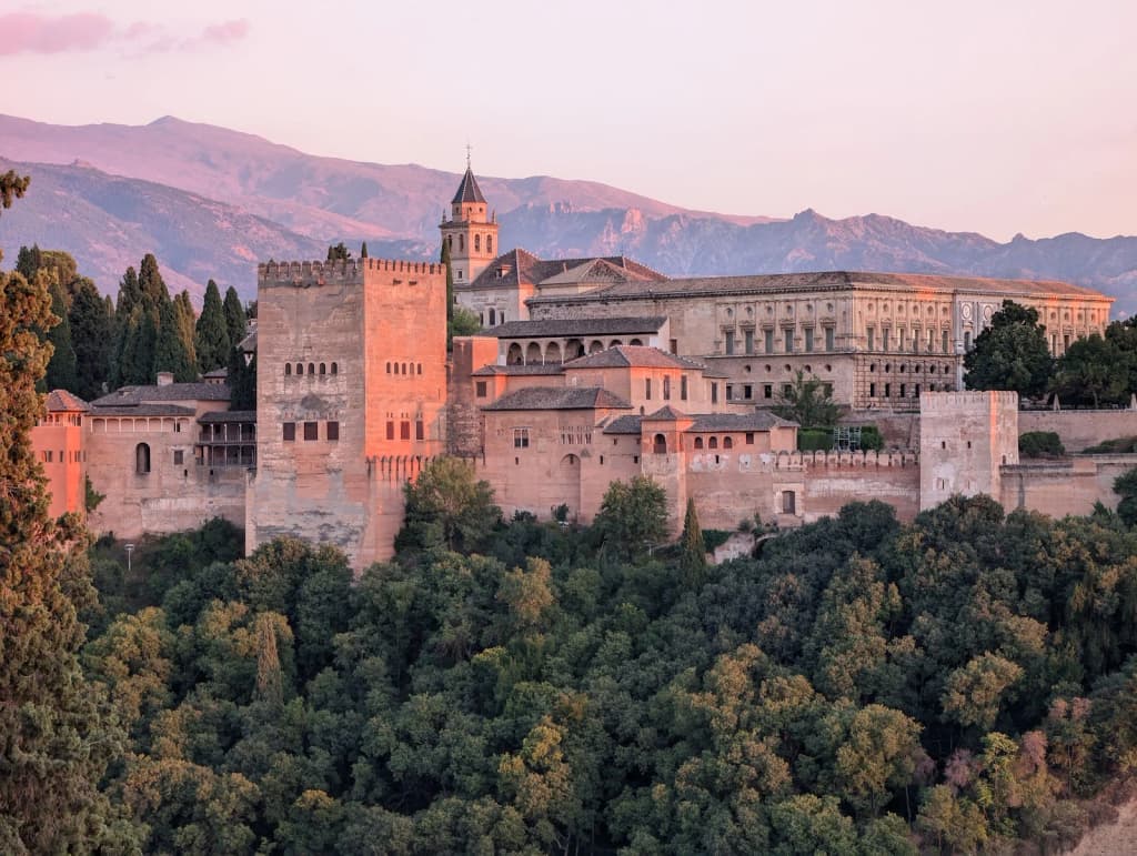 The Alhambra palace glowing at sunset, Granada, Spain