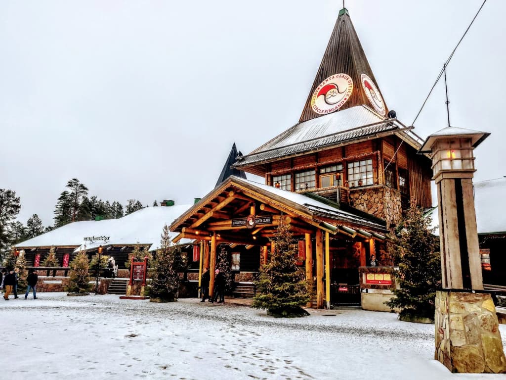 Cozy restaurant with glass walls, diners watching the snowy landscape