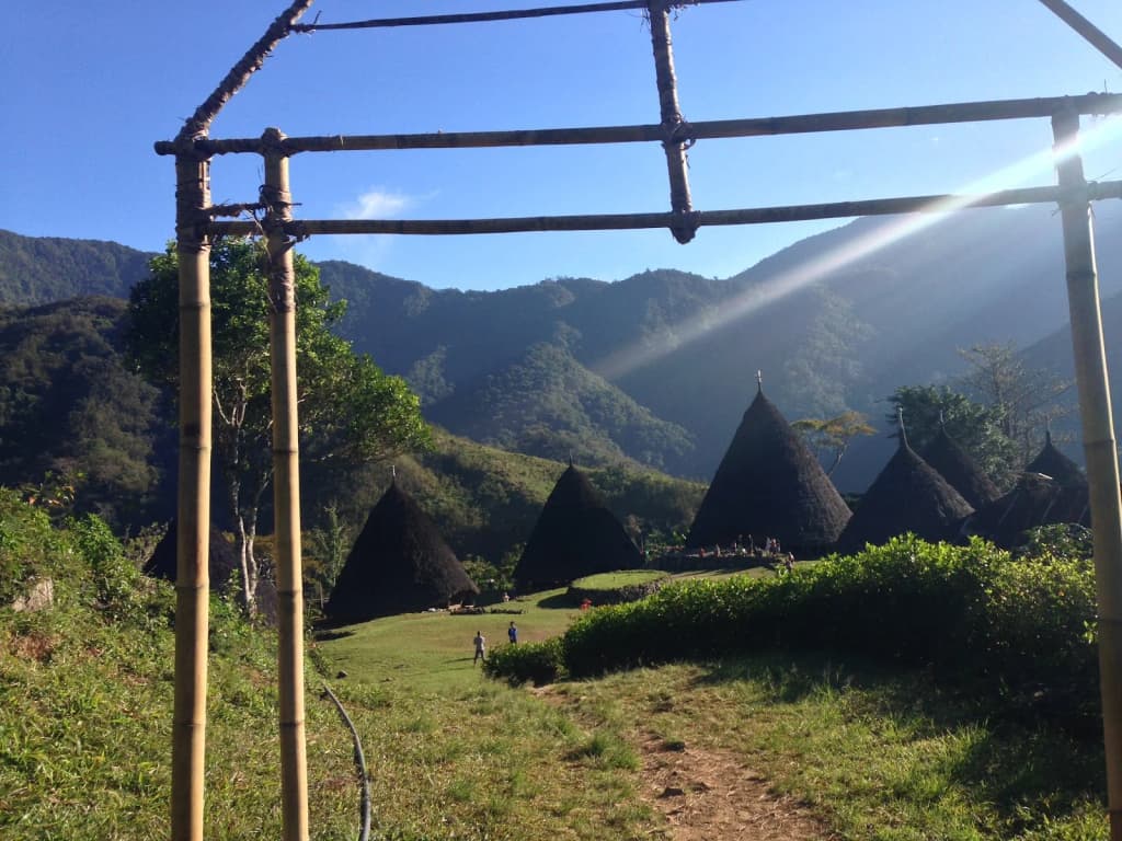 A Manggarai woman weaving traditional fabric inside a mbaru niang