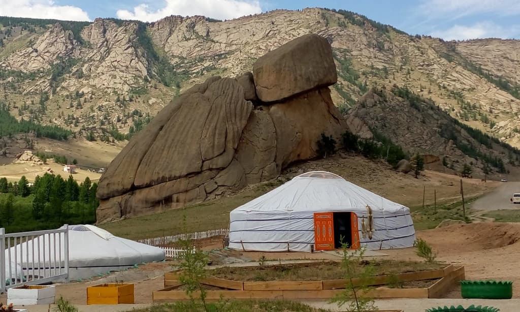 Granite Turtle Rock formation, hikers at its base