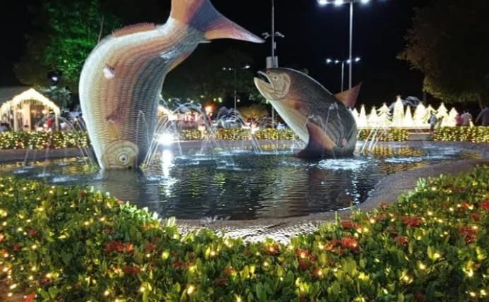 Inside a massive cave with blue water and rock formations