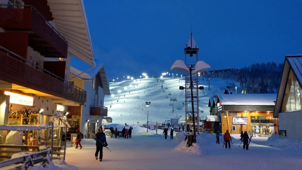 Tourists in survival suits floating in the icy water beside the Sampo icebreaker