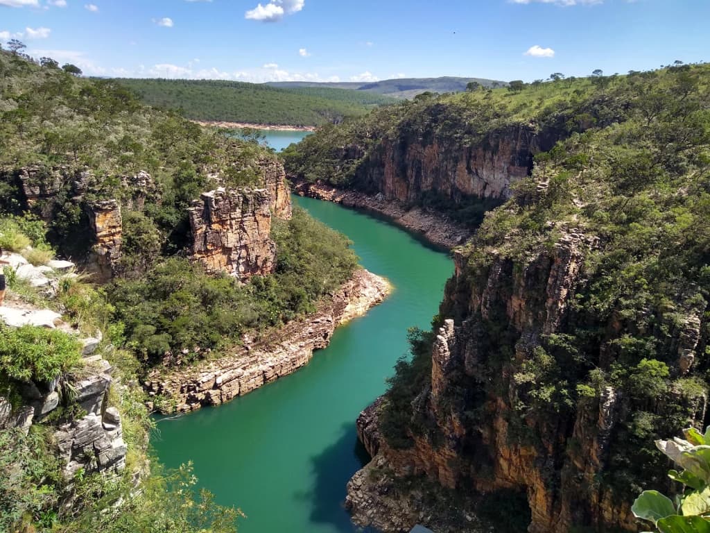 Hikers crossing a rocky trail with panoramic views