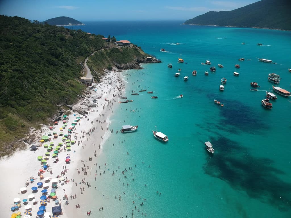 View from the trail to Praia do Forno, overlooking turquoise water and lush hills