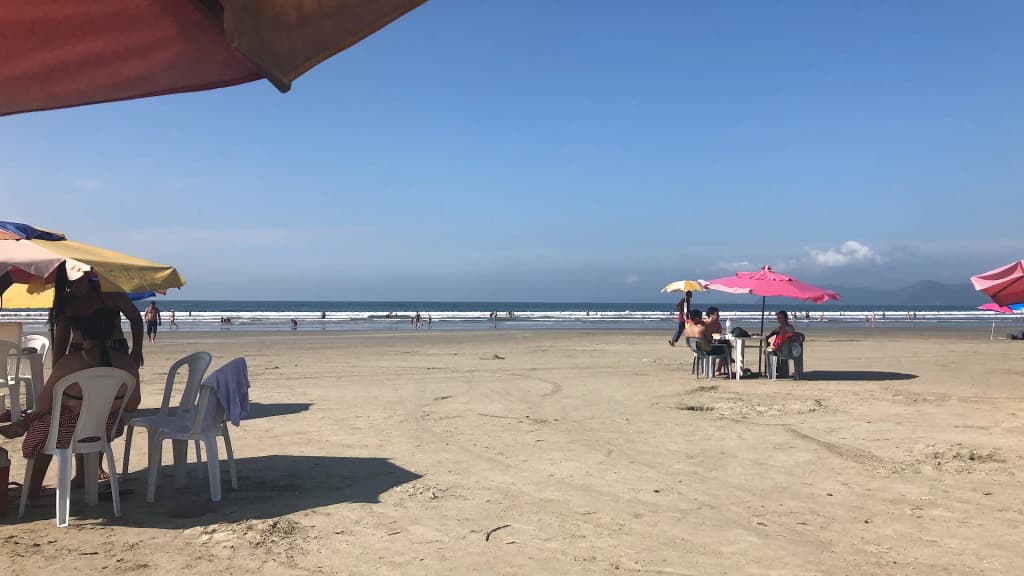 Surfers and skyline at São Lourenço Beach