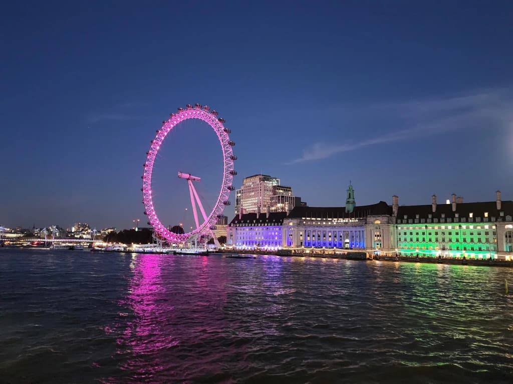 London Eye at dusk, glowing over the Thames