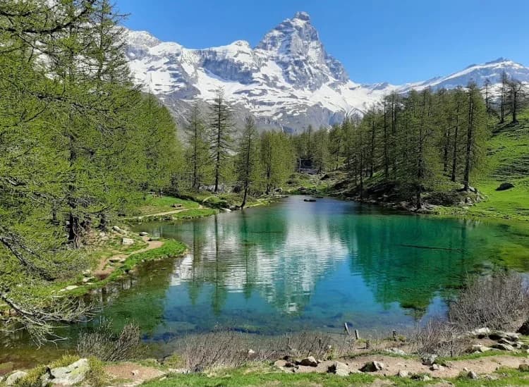 Crystal-clear lake with mountains reflected in the water