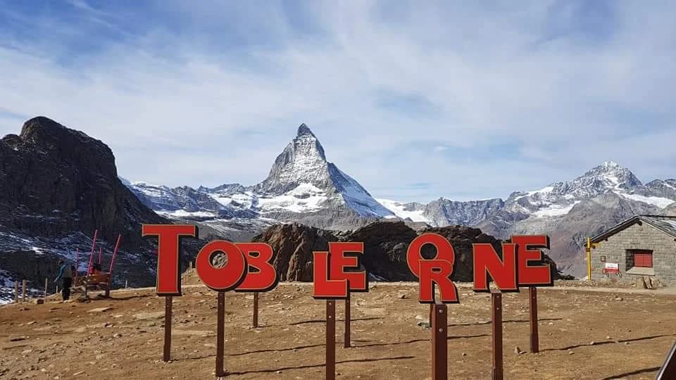 Red Bernina Express train crossing a mountain viaduct
