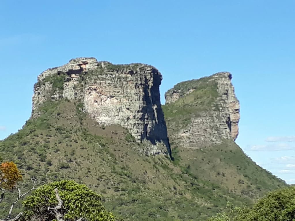 Senderista diminuto entre acantilados y valles verdes en Chapada Diamantina