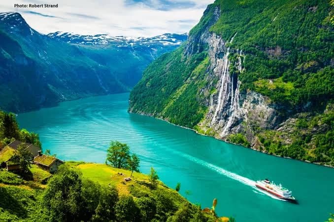 Emerald fjord waters and towering cliffs in Geirangerfjord, Norway