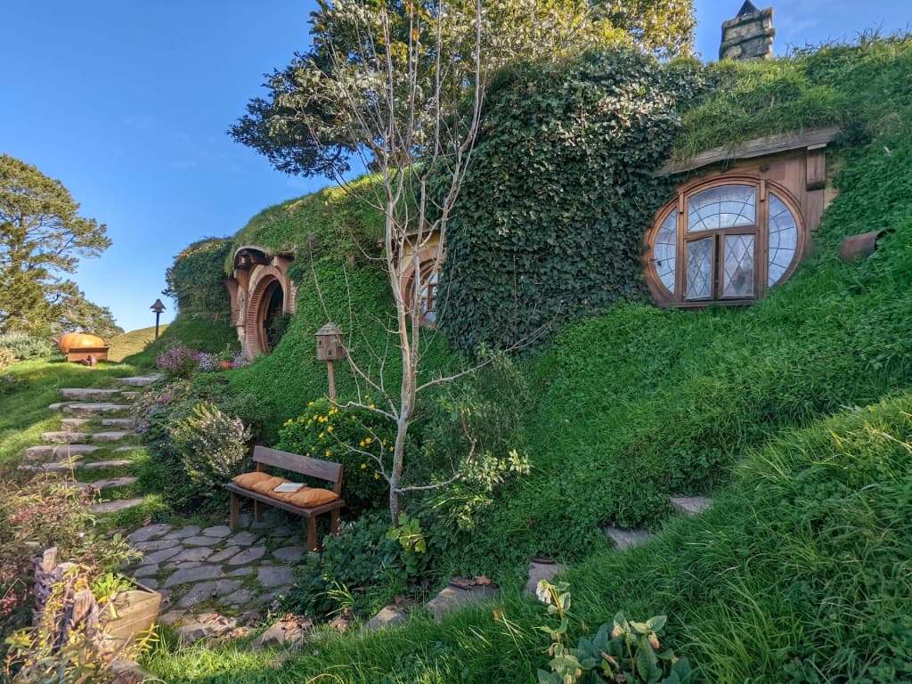 Hobbiton movie set, rolling green hills and hobbit holes