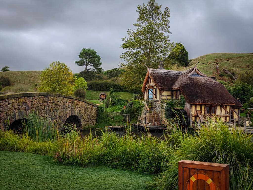 Hobbiton set with lush gardens and round doors