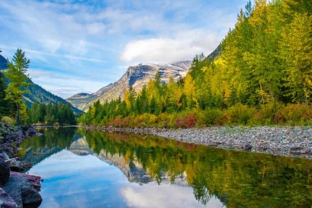 Abandoned mine buildings beside a blue lake in Montana