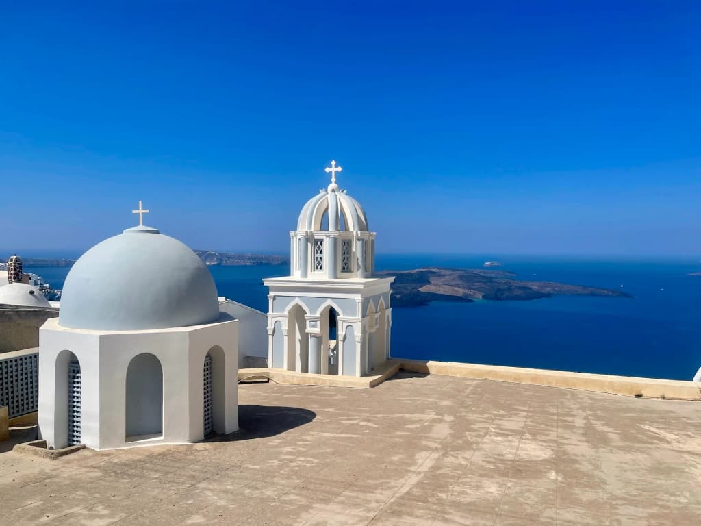 Santorini caldera at sunset, volcanic cliffs and white houses