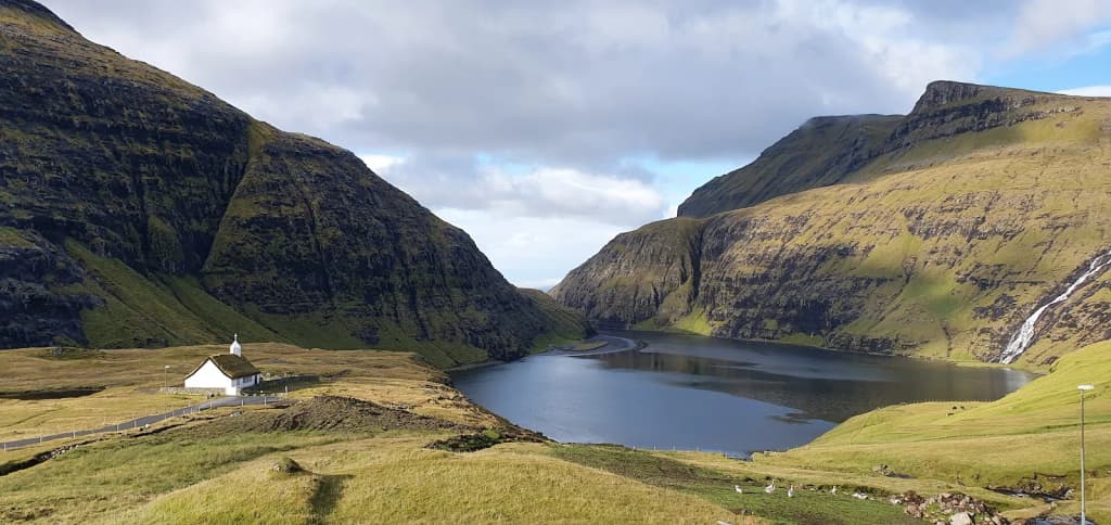 A lone tent pitched beside a dramatic fjord, Faroe Islands