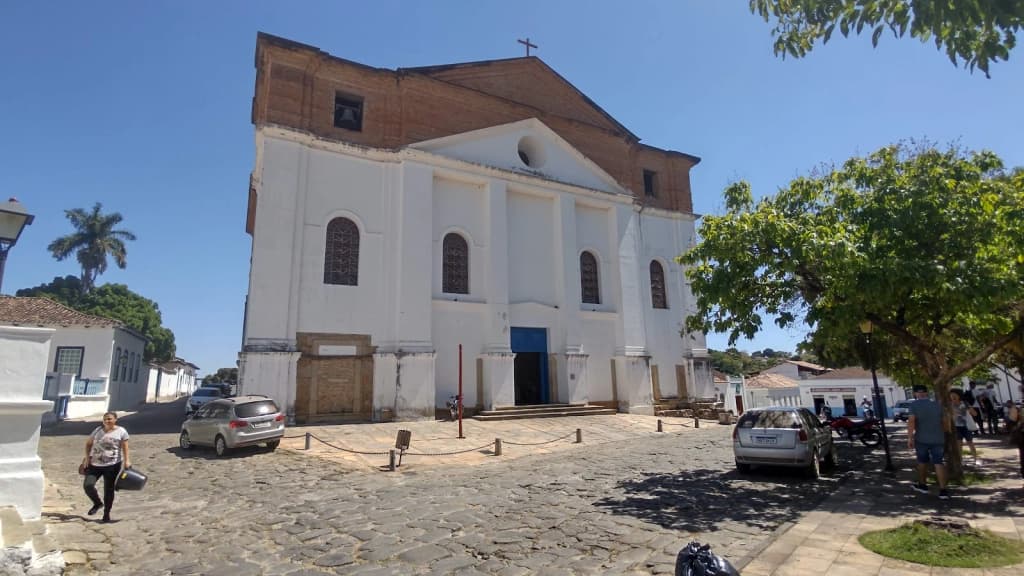 Twilight over Goiás: colonial rooftops, golden streetlights, and the silhouette of the Serra Dourada.