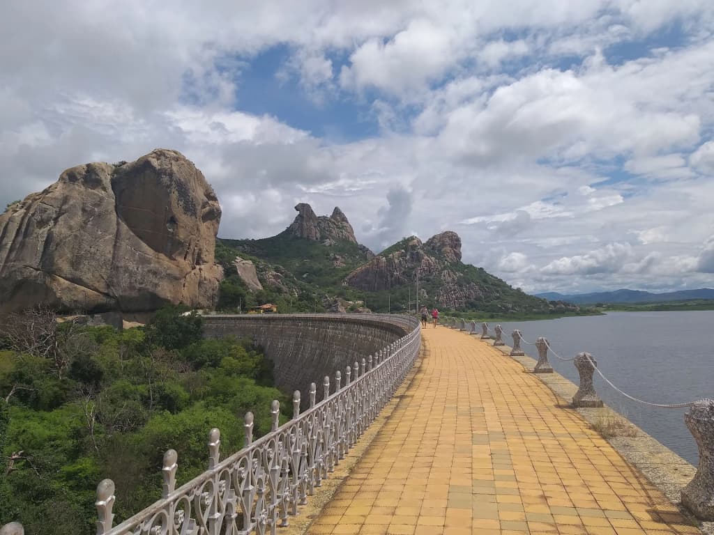 Pedra da Galinha Choca rising above green hills in Quixadá