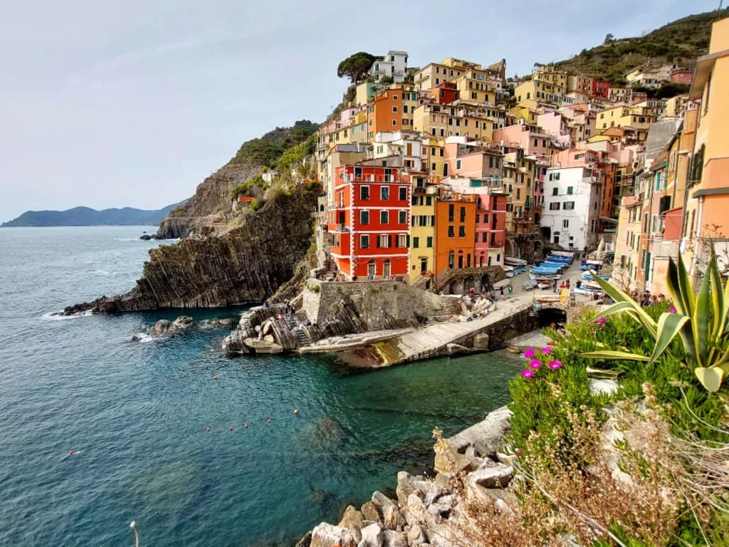 A dramatic Italian cityscape with ancient stone buildings and a river winding through the heart of the city