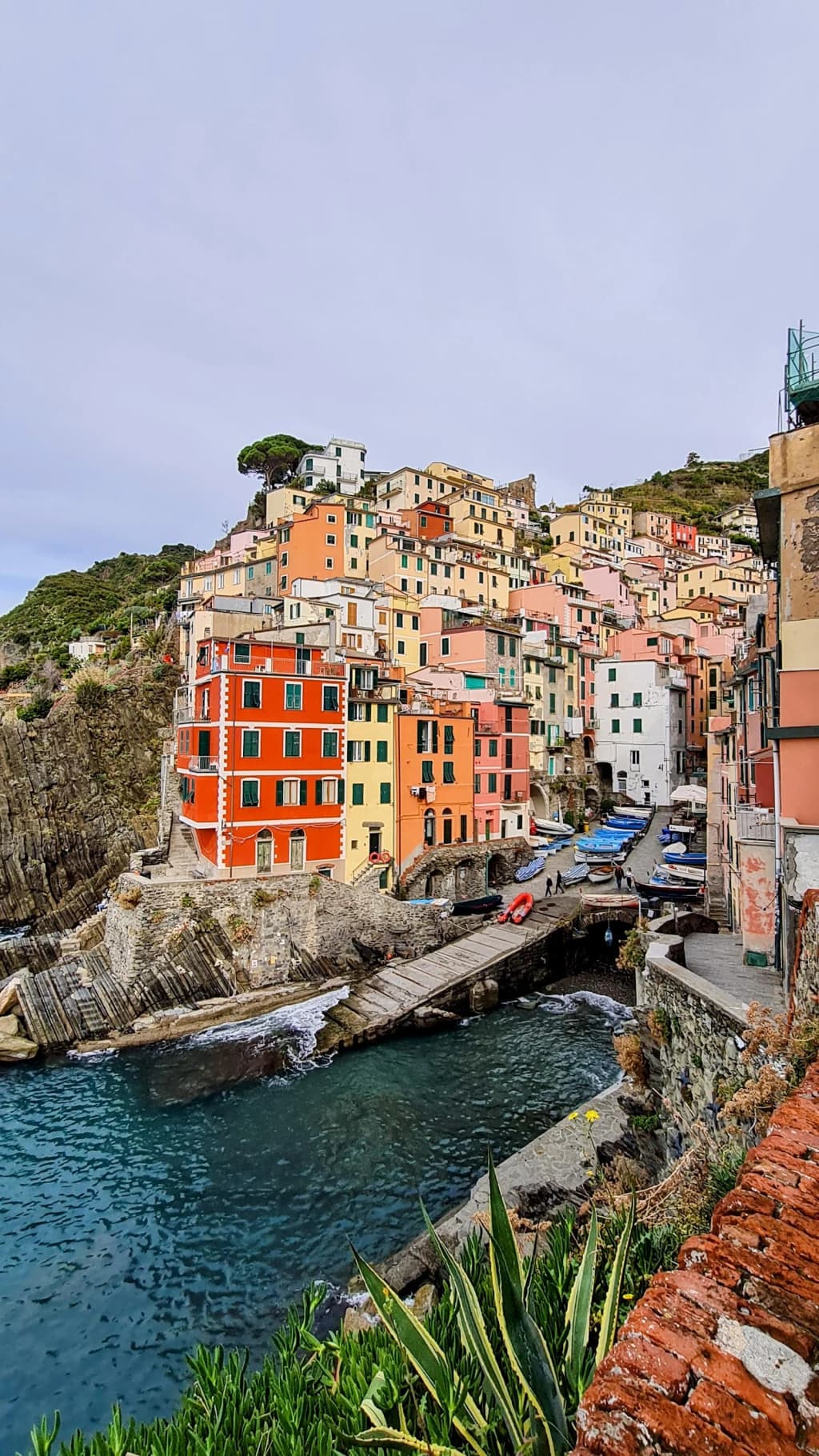 A misty mountain landscape in the Dolomites, with jagged peaks and a winding trail